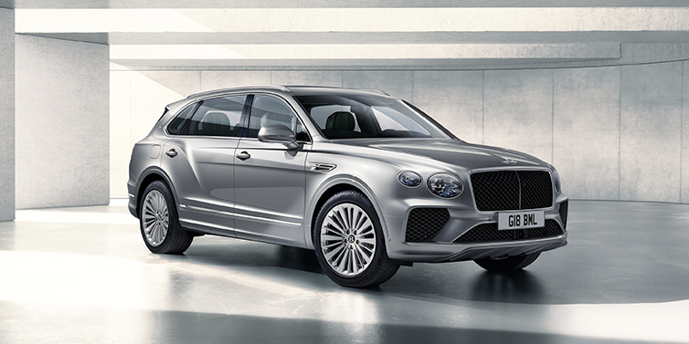 Bentley Athens Bentley Bentayga Extended Wheelbase SUV front three quarter in Moonbeam paint with a grey background